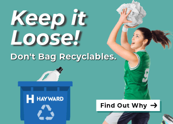 basketball player putting recycling in cart